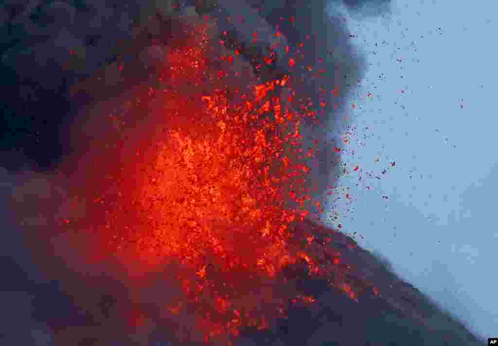 The Mayon volcano spews molten lava, Jan. 25, 2018, during its sporadic eruption as seen from a village in Legazpi city, Albay province, around 340 kilometers (200 miles) southeast of Manila, Philippines.