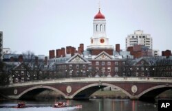 In this March 7, 2017 file photo, rowers paddle along the Charles River past the Harvard College campus in Cambridge, Mass. (AP Photo/Charles Krupa, File)