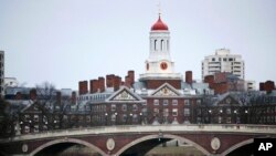 In this March 7, 2017 file photo, rowers paddle along the Charles River past the Harvard College campus in Cambridge, Mass. (AP Photo/Charles Krupa, File)