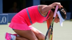 FILE - China's Peng Shuai falls to her knees during 2014 U.S. Open semifinals against Caroline Wozniacki of Denmark, Sept. 5, New York, New York.