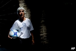 FILE - Elba Selva, a former player of Argentina national women's soccer team, poses for a photo in Buenos Aires, Argentina, Jan. 31, 2019. Selva represented Argentina during the Women's World Cup in 1971.