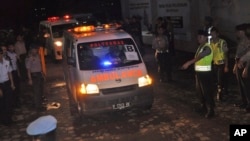 Ambulances carrying the body of executed drug convicts, Dutch national Ang Kiem Soe and Brazilian national Marco Moreira, leave Nusakambangan island, Central Java, Indonesia, Jan. 18, 2015 AP Photo/Wagino)