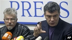 Russian opposition leaders Boris Nemtsov, right, and Eduard Limonov, face the media in Moscow after they were released from detention, Jan 17, 2011