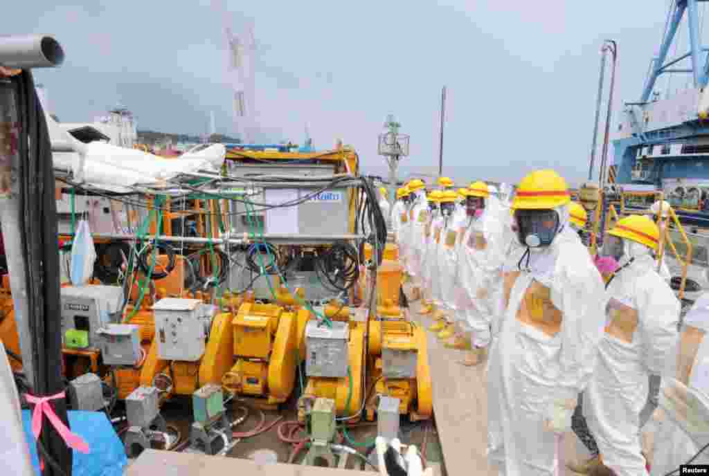 Members of a Fukushima prefecture panel, which monitors the safe decommissioning of the nuclear plant, inspect the construction site of the shore barrier, August 6, 2013.