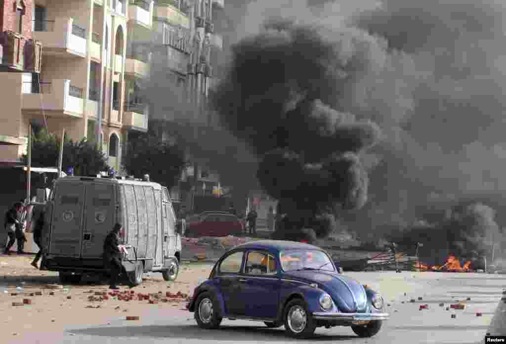 Smoke rises as Egyptian security forces clash with supporters of deposed Egyptian President Mohamed Morsi in Nasr City, Cairo, Jan. 8, 2014.