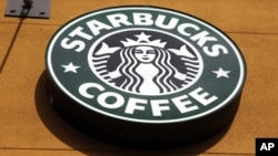 This Jan. 3, 2012 file photo shows the Starbucks Coffee logo in Mountain View, California.