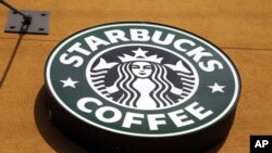 FILE- The Starbucks Coffee logo is seen in Mountain View, California, Jan. 3, 2012.