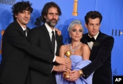 FILE - Anthony Rossomando, from left, Andrew Wyatt, Lady Gaga and Mark Ronson pose in the press room with the award for best original song, motion picture for "Shallow" from the film "A Star Is Born" at the 76th annual Golden Globe Awards in Beverly Hill, California, Jan. 6, 2019.