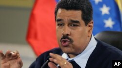 FILE - Venezuelan President Nicolas Maduro gestures during a news conference at Miraflores presidential palace in Caracas, Aug. 24, 2015.