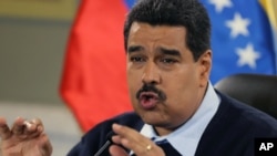 FILE - Venezuelan President Nicolas Maduro gestures during a news conference at Miraflores presidential palace in Caracas, Venezuela, Aug. 24, 2015.