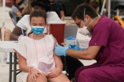 Francesca Anacleto, 12, receives her first Pfizer COVID-19 vaccine shot from nurse Jorge Tase, Wednesday, Aug. 4, 2021, in Miami Beach, Fla. (AP Photo/Marta Lavandier, File)