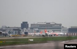 FILE - Aircraft taxi at Gatwick Airport in southern Britain, December 17, 2015.