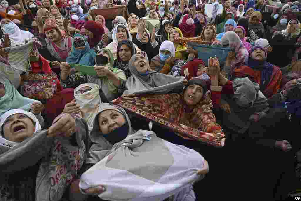 Muslim devotees react as a priest displays a relic believed to be a hair from the beard of Prophet Mohammad during the last Friday of Eid Milad-un-Nabi, which marks the birth anniversary of the Prophet, at the Hazratbal Shrine in Srinagar.