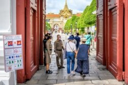 Visitors enter the Grand Palace in Bangkok on June 7, 2020, as it reopened for visitors following restrictions to halt the spread of the COVID-19 novel coronavirus. (Photo by Mladen ANTONOV / AFP)