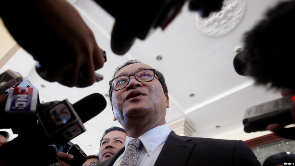 FILE - Sam Rainsy, leader of the Cambodia National Rescue Party (CNRP), speaks to media after a meeting at the National Assembly in Phnom Penh.