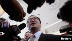 FILE - Sam Rainsy, President of the Cambodia National Rescue Party (CNRP), speaks to media after a meeting at the National Assembly in central Phnom Penh.