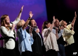 Members of the worship team sing during the Southern Baptist Convention annual meeting, June 13, 2017, in Phoenix.