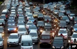 In this Sept. 24, 2010 photo, motorists are stuck in traffic jam during an evening rush hour at the main business district in Jakarta, Indonesia.