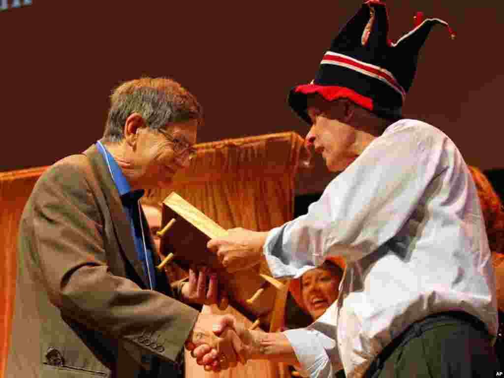 Karl Halvor Teigen (L) of the University of Oslo, Norway, receives a 2011 Ig Nobel prize, for trying to understand why, in everyday life, people sigh, during the 21st annual Ig Nobel prize ceremony at Harvard University in Cambridge, Massachusetts Septemb