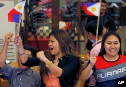 Filipinos cheer moments after the Hague-based U.N. international arbitration tribunal ruled in favor of the Philippines in its case against China on the dispute in South China Sea, July 12, 2016 in Manila, Philippines.