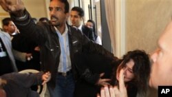A Ministry of Information official, left, yells at the press to stop filming as he grabs Iman Al-Obeidi, who said she spent two days in detention after being arrested at a checkpoint in Tripoli, Libya, and was sexually assaulted by up to 15 men while in
