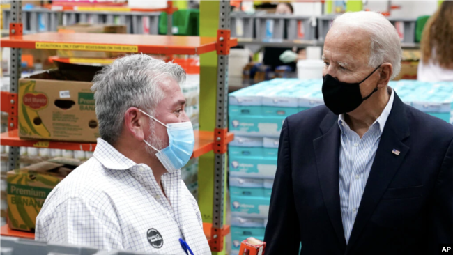 President Biden speaks with a volunteer at the Houston Food Depot (February 26, 2021)