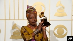 FILE - Angelique Kidjo, seen in this Feb. 15, 2016 photo with award for best world music album for "Sings" at the 58th annual Grammy Awards, has won a human rights award, along with three African youth activist movements, for their work defending freedom of expression and peaceful protest.