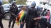 Zimbabwe police detain women protesting against woman trafficking.