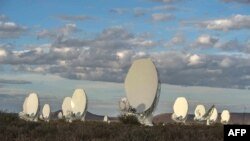 FILE - Part of a 64-dish radio telescope system is seen during an official unveiling ceremony, July 13, 2018, in Carnarvon, South Africa. A Canadian radio telescope has detected repeating radio waves from deep space.