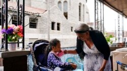 Amanda Brebe, 75, tends to her granddaughter Zuniga Gonzales, 7, in the Kensington section of Philadelphia, Sunday, May 16, 2021