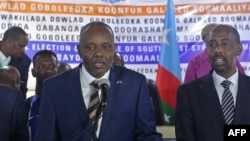 Newly elected Somalia's autonomous South West State President Abdiaziz Hassan Mohamed, left, delivers his speech after being elected among five candidates by legislators in Baidoa, Somalia, Dec. 19, 2018.