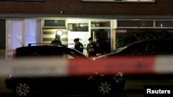 Police officers are seen in front the building where the main suspect of the shooting has been arrested in Utrecht, Netherlands, March 18, 2019. 