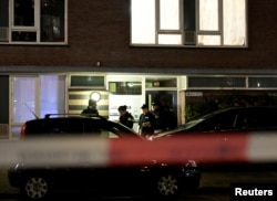 Police officers are seen in front the building where the main suspect of the shooting has been arrested in Utrecht, Netherlands, March 18, 2019.
