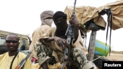 Milisi dari kelompok militan Islamis Ansar Dine, duduk di atas kendaraan mereka di Mali utara (foto: dok). Ansar Dine mengaku telah merebut kota di Mali tengah dari pasukan Mali. 