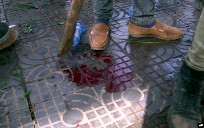 In this image made from video, blood is seen on the ground after an explosion at a rally for Ethiopia’s new prime minister, in Addis Ababa, Ethiopia, June 23, 2018.