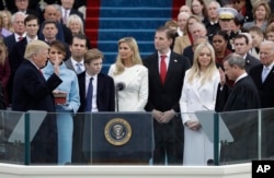 Donald Trump is sworn in as the 45th president of the United States by Chief Justice John Roberts as Melania Trump and his family looks on during the 58th Presidential Inauguration at the U.S. Capitol in Washington, Jan. 20, 2017.