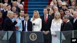 Donald Trump is sworn in as the 45th president of the United States by Chief Justice John Roberts as Melania Trump and his family looks on during the 58th Presidential Inauguration at the U.S. Capitol in Washington, Jan. 20, 2017. 