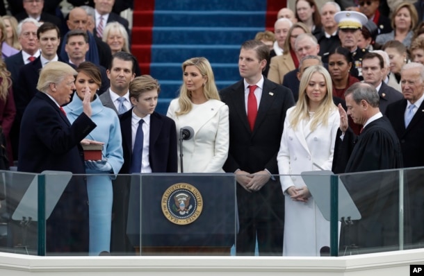 Donald Trump is sworn in as the 45th president of the United States by Chief Justice John Roberts as Melania Trump and his family looks on during the 58th Presidential Inauguration at the U.S. Capitol in Washington, Jan. 20, 2017.