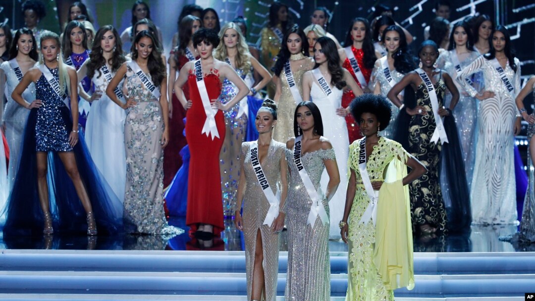 The final three contestants Miss South Africa Demi-Leigh Nel-Peters, Miss Colombia Laura Gonzalez, and Miss Jamaica Davina Bennett wait for the winner to be announced at the Miss Universe pageant Sunday, Nov. 26, 2017, in Las Vegas.