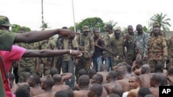 Soldiers loyal to Alassane Ouattara point to men they claim to recognize among several dozen prisoners captured during fighting and patrols in Abidjan, Ivory Coast, April 6, 2011