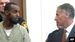 FILE - Abdirahman Sheik Mohamud, left, speaks with his attorney, Sam Shamansky, during a hearing to set bond on charges of money laundering and providing support for terrorism in Columbus, Ohio, Feb. 25, 2015.