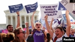 Demonstrators celebrate at the U.S. Supreme Court after the court struck down a Texas law imposing strict regulations on abortion doctors and facilities that its critics contended were specifically designed to shut down clinics in Washington June 27, 2016