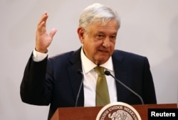 FILE - Mexico's President Andres Manuel Lopez Obrador gestures during a meeting in Mexico City, Mexico, Dec. 17, 2018.