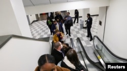 U.S. Capitol Police evacuate journalists and House press staff members from the Capitol to a connected office building, in Washington, U.S., January 6, 2021.