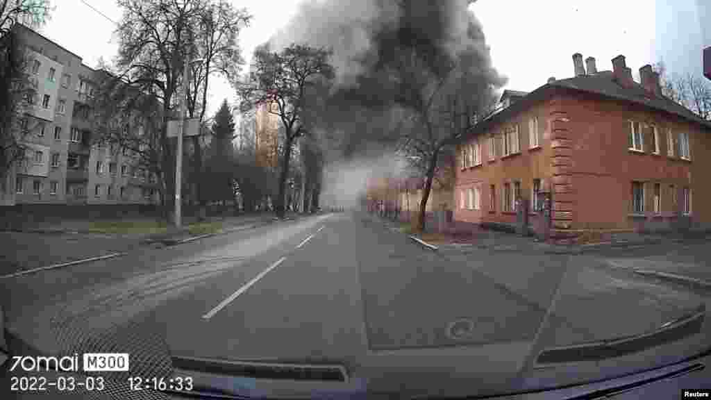 Dash cam footage shows people emerging through smoke after a blast from a missile strike during Russia&#39;s invasion in Chernihiv, Ukraine, March 3, 2022 in this social media video still image obtained by REUTERS.