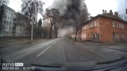 Dash cam footage shows people emerging through smoke after a blast from a missile strike during Russia's invasion in Chernihiv, Ukraine March 3, 2022 in this social media video still image obtained by REUTERS.