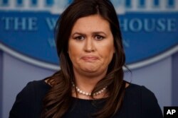 White House press secretary Sarah Sanders listens to a question during a press briefing at the White House, March 11, 2019, in Washington.