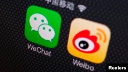 FILE- A picture illustration shows icons of WeChat and Weibo app in Beijing, Dec. 5, 2013. 