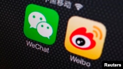 FILE - A picture illustration shows icons of WeChat and Weibo app in Beijing.