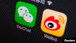 FILE - A picture illustration shows icons of WeChat and Weibo apps in Beijing, Dec. 5, 2013.